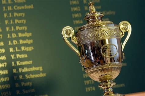 The men's trophy has something to do with the tradition of british navy captains putting a pineapple atop their gateposts on return. The men's trophy in front of a list of former Wimbledon ...