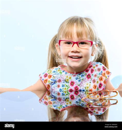 Close Up Portrait Of Cute Little Girl Wearing New Glasses Stock Photo