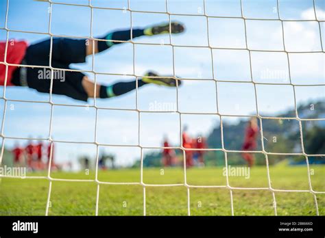 Goalkeeper Catching A Ball During A Soccer Match Stock Photo Alamy