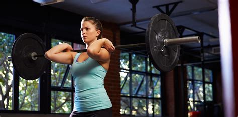 Woman In Gym Lifting Weights - Simply Gym
