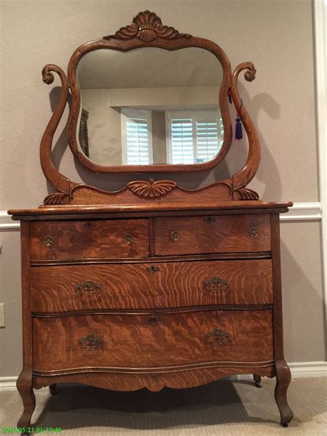 An Old Dresser With A Mirror On Top