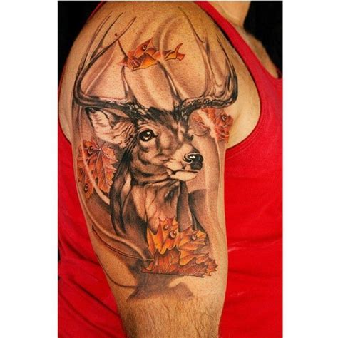 A Mans Arm With A Deer And Leaves Tattoo On The Left Side Of His Arm
