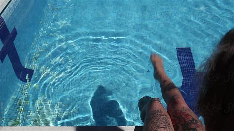Anonymous Tattooed Woman Splashing Water In A Swimming Pool By Stocksy Contributor Kkgas