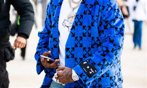 Boogie will also feature unreleased music from the late rapper, as well as a cameo from fellow. Rapper Pop Smoke, wearing a blue Off-White coat, is seen ...