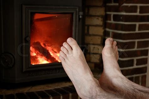 Two Male Naked Feet Warming Up In Front Stock Image