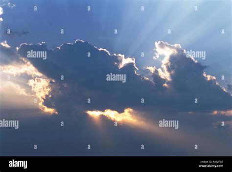 Sunrays Through Clouds In Sky Stock Photo Alamy