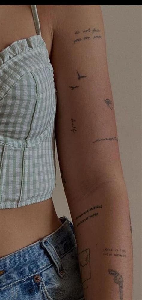 A Woman S Arm With Tattoos On It