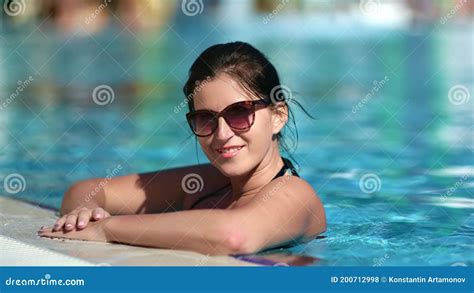 happy woman posing at swimming pool enjoying summer vacation medium close up shot on 4k red