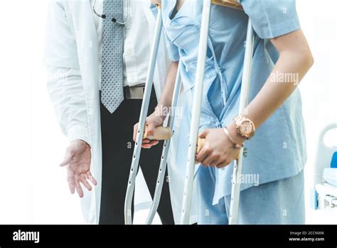 Doctor Takes Care Of Patient In Crutch At Hospital Stock Photo Alamy