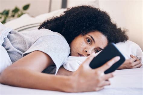 cellphone mental health and woman in her bed with depression while watching videos on social