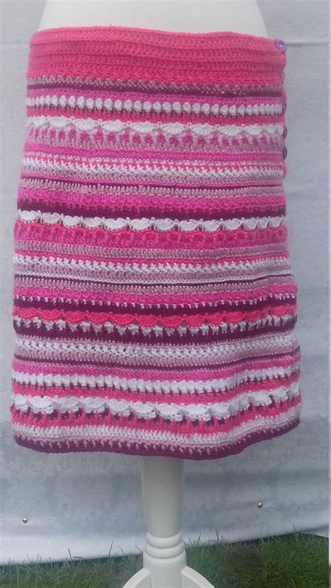 A Pink And White Crocheted Skirt On A Mannequins Head