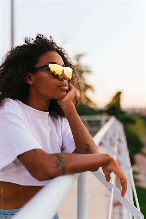 Side View Of A African American Woman Wearing Sunglasses By Stocksy Contributor Kike Arnaiz
