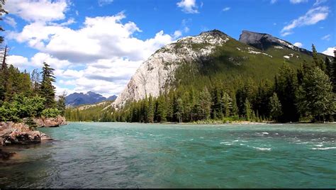 Bow River With A Rapid Current In A Valley Between Mountains In Banff