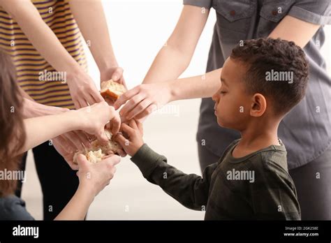 Cute Little Boy Taking Piece Of Bread From Hand Poverty Concept Stock