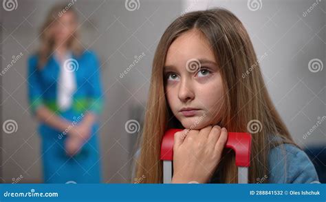 Close Up Upset Teenage Girl Looking Back At Blurred Woman Stewardess
