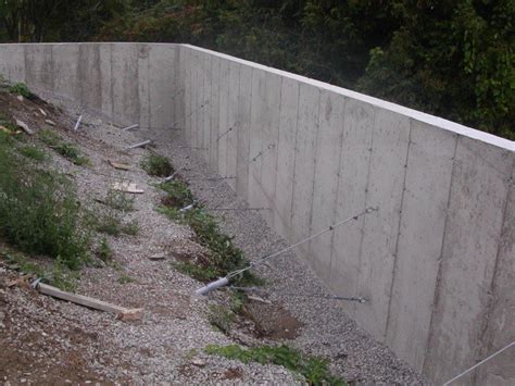 Concrete block retaining wall retaining walls foyers rustic outdoor fireplaces manchester interlocking pavers design jardin backyard patio masonry retaining walls are built with a reinforced concrete base as an anchor and a wall of hollow concrete blocks reinforced with 12mm steel bars. Concrete Retaining Wall Design and Installation -Buchheit ...