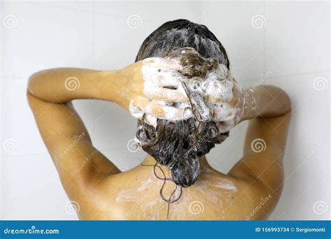 Woman Applying Shampoo Onto Her Hair In Bathroom Young Woman In Shower Washing Hair With