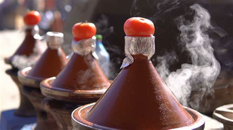 Traditional Moroccan Tajine Food Cooking In Tajine Pots On The Fire