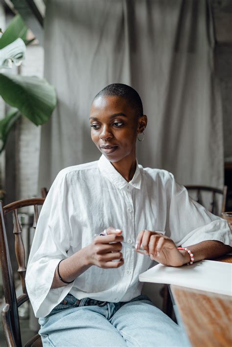 Dreamy Trendy Black Woman Sitting At Table · Free Stock Photo
