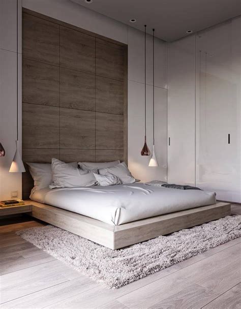 A Large Bed Sitting On Top Of A Wooden Floor Next To A Wall Mounted Light