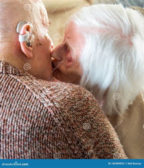 Elderly Couple Kissing And Showing Affection Towards One Anotherliving