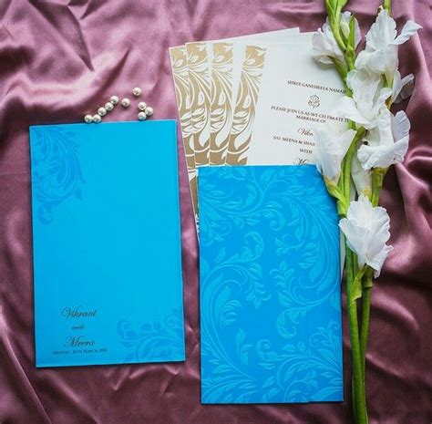 A floral pattern is shown on this shimmery. Floral pattern Marriage invitation cards designer ...