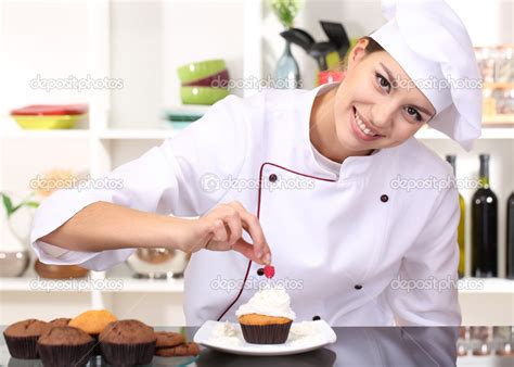 Young Woman Chef Cooking Cake In Kitchen Stock Photo By ©belchonock