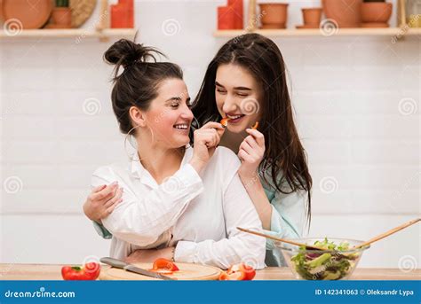 Two Brunettes Feed Each Other With Pepper Slices Stock Image Image Of