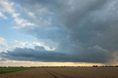 Dramatic Looking Storm Cloud Over The Dutch Countryside At Dusk Stock