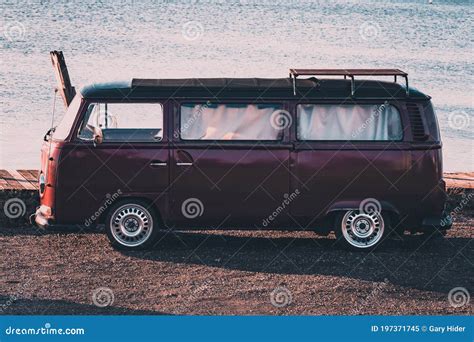 A Vintage Camper Van Parked Near The Sea At Sunset Stock Image Image
