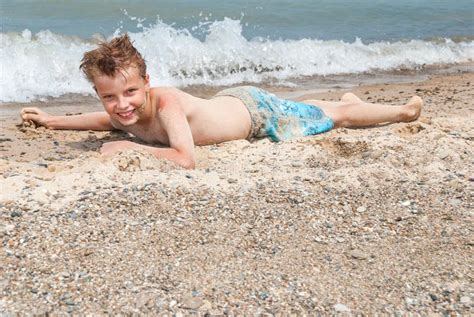 The Boy Sunbathes On The Beach Indiana Dunes Usa Stock Photo Image