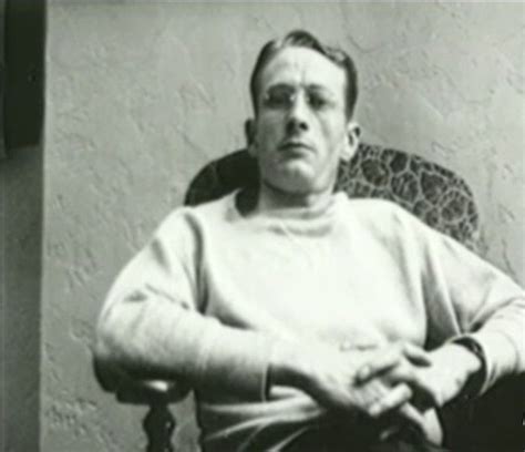 An Old Black And White Photo Of A Man Sitting In A Chair With His Arms