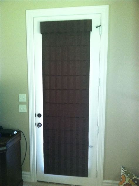 Brown Striped Classic Fold Roman Shade Installed On A Back Door In