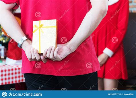 Hands Of Man Wear Red T Shirts Holding Gold T Box Behind His Back Surprise For Girlfriend
