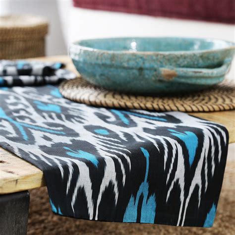 Table runners made of sumptuous fabrics can add a touch of elegance to a table. TURQUOISE AND BLACK IKAT TABLE RUNNER