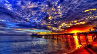 Sunset Beach Sea Pier Platform On Wooden Pillars Sky