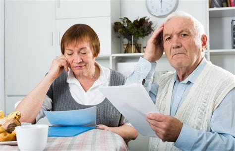 Elderly Couple Consider Contract Stock Photo Image Of Installments