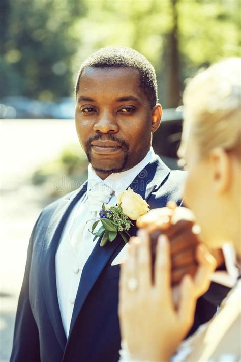 Handsome African American Groom Looks At Adorable Bride Stock Photo