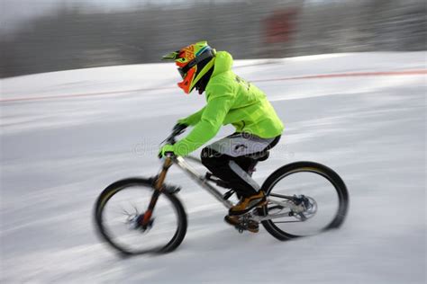 Cyclist Extreme Riding Mountain Bicycle In Snow Editorial Stock Image