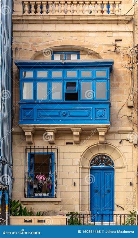 Facade With Blue Door Window Shutters And Traditional Maltese Wooden