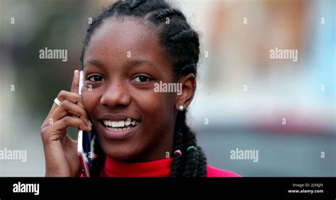 Happy Black Teen Girl Smiling And Laughing Talking On Phone Outside
