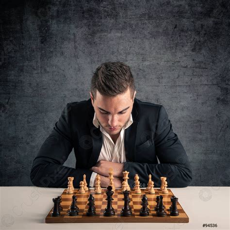 Man Playing Chess Isolated On Dark Grunge Background Stock Photo
