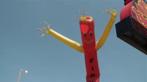 A Shot Of A Red Wacky Waving Inflatable Arm Flailing Tube Man Filmati