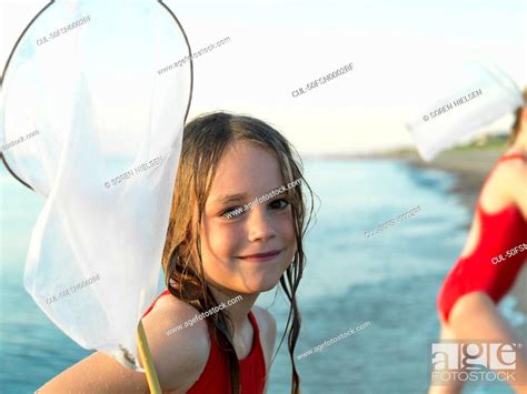 Girls Fishing In Shallow Water Stock Photo Picture And Royalty Free