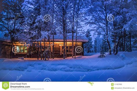 Traditional Wooden Cabin In Winter Wonderland At Night Stock Photo