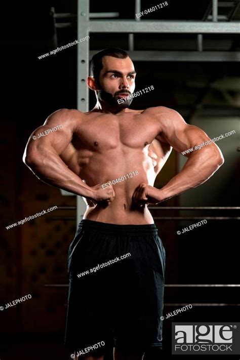 Portrait Of A Young Fit Man Performing Front Lat Spread Pose Muscular