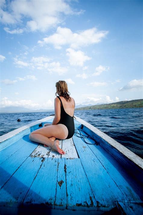 woman sitting on wooden boat in 2020 travel travel destinations unique best travel credit cards