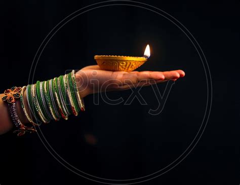 Image Of Indian Women Holding A Diwali Lamp Diya In Hand Closeup Shot