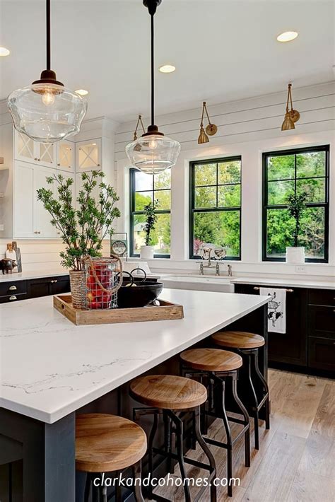 Vintage Inspired Pendant Lights Hang Above An Expansive Island In This
