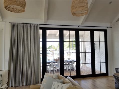 It's main floor condo with 11' ceilings, and the window is essentially a glass wall with a sliding door leading to a backyard, and has a top glass panel and a bottom step. Motorized Drape on Large Sliding Glass door
